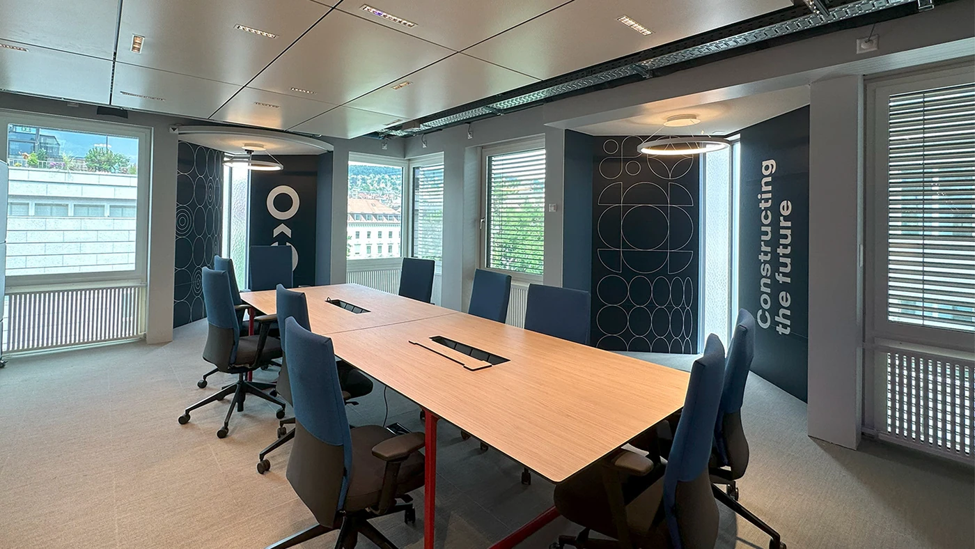 Constructor office meeting room with branded glass partitions and vertical typography