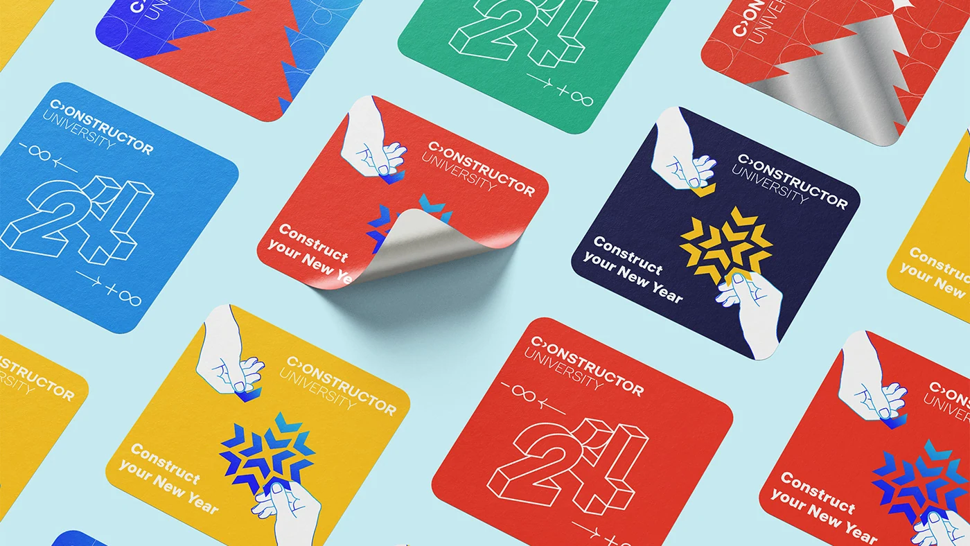 Constructor University New Year cards with colourful geometric snowflakes and illustrated hands