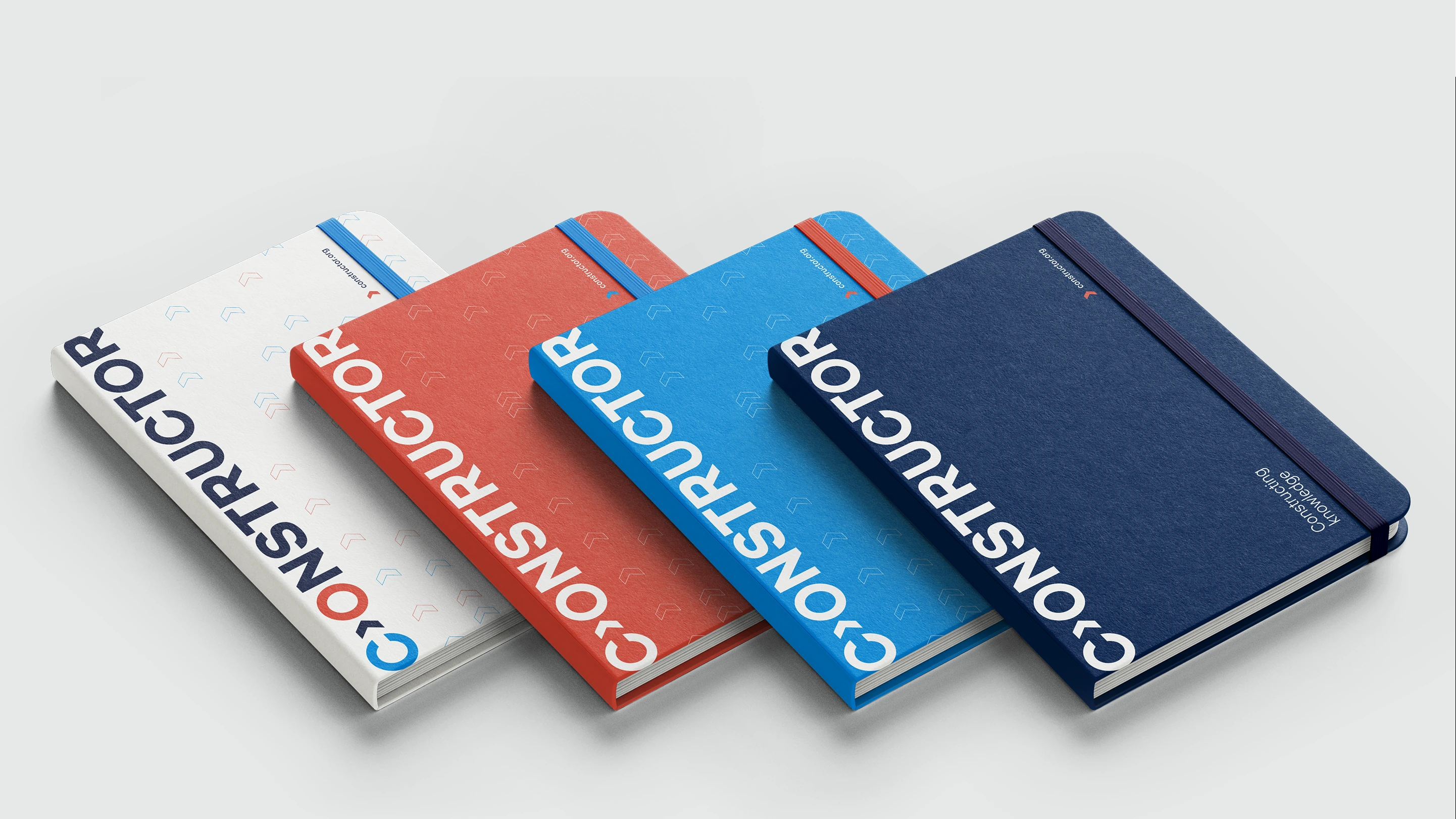 Four Constructor notebooks in white, coral, cyan and navy with original branded covers